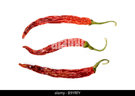 Three red sun dried chilli peppers Stock Photo