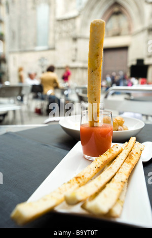 Breadstick dipped in sauce Stock Photo