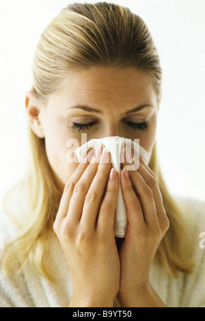 Woman blowing nose Stock Photo