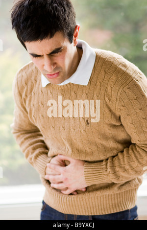 Man holding stomach Stock Photo