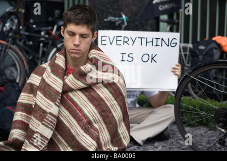 Protestor takes a meditative break during peace camp protest against G20 summit in London, April 1 2009 Stock Photo