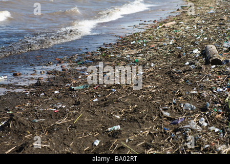 Shore littered with trash and debris Stock Photo