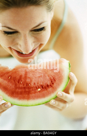 Woman eating slice of watermelon Stock Photo