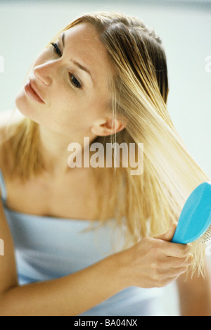 Woman brushing hair Stock Photo