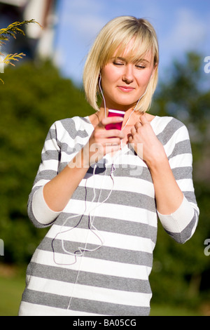 Girl listening to 'iPod' Stock Photo