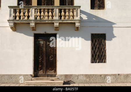 The aged wooden doors and shuttered windows on a Venetian Palace Stock Photo