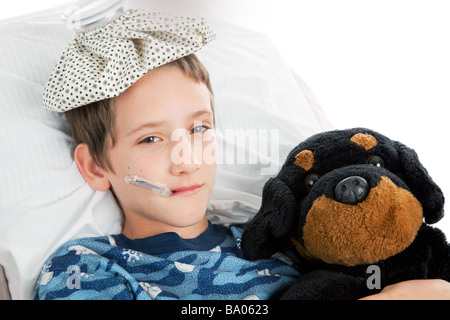 Horizontal view of a little boy home sick from school  Stock Photo