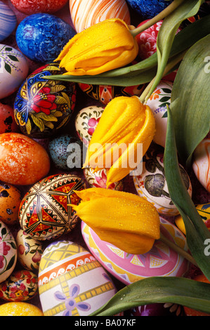 Easter eggs and yellow tulips on shabby blue and gray concrete ...