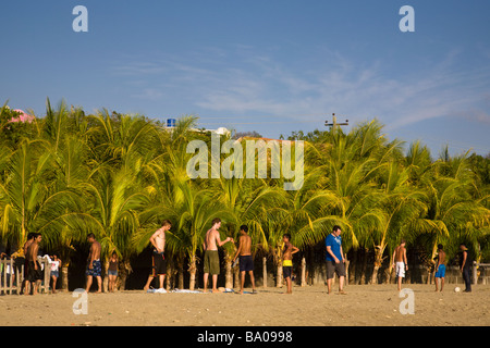 Group of young men playing football on the beach in San Juan del Sur, Nicaragua. Stock Photo
