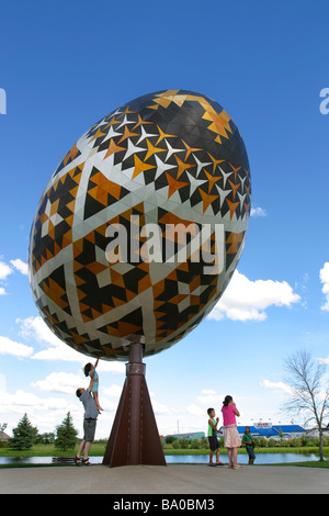 Tourists visit the world's largest Pysanka, or Ukranian Easter Egg in Vegreville, Alberta, Canada. Stock Photo