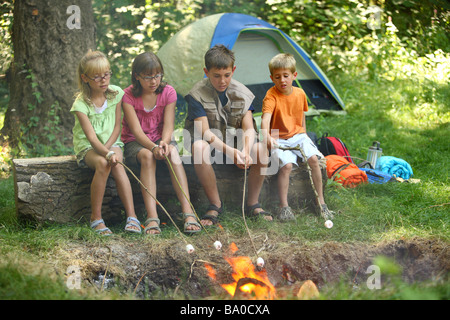 Group of children roasting marshmallows Stock Photo
