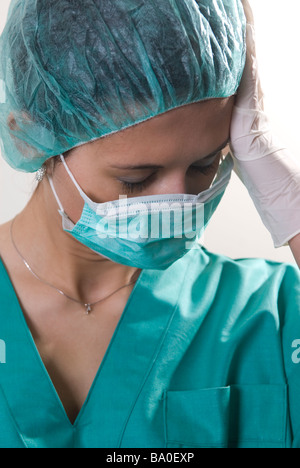 Tired nurse head in hand Stock Photo