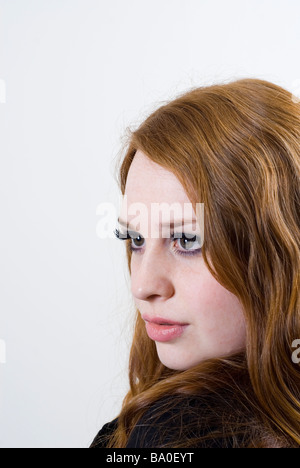 Beautiful young woman looking over shoulder Stock Photo