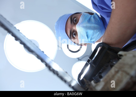 Crazy surgeon with chainsaw Stock Photo
