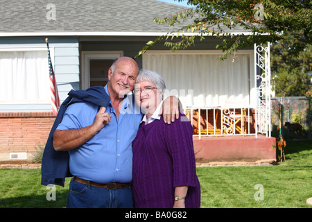 Senior couple in front of home Stock Photo