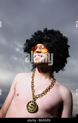 Funny guy with afro wig glasses and bling Stock Photo