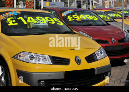 Renault used second hand car dealership forecourt display row in line of dealer cars with sale price tag label Ilford East London England UK Stock Photo