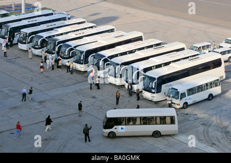 Abu Dhabi port looking down on cruise ship passengers boarding coaches for guided tour excursions around nearby attractions Stock Photo