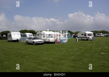 Caravans in a sunlit field near Port Eynon South Wales, with a blue sky behind. Stock Photo