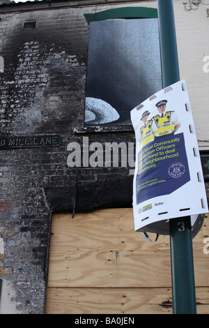 A Police anti-social behaviour sign outside a fire damaged building in a U.K. city.