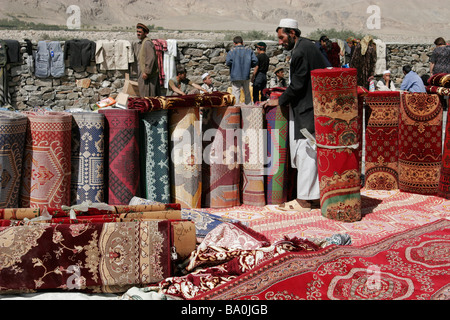 Traditional Afghan carpets on sale, transborder market near Ishkashim on the border between Tajikistan and Afghanistan Stock Photo