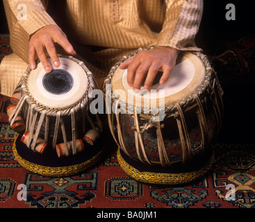 A Tabla (dayan tabla) being played, with fingers and the palm of a hand. (Zakir Hussain is the player) Stock Photo