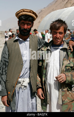 Afghan men wearing traditional hat on the transborder market near Ishkashim on the border between Tajikistan and Afghanistan Stock Photo