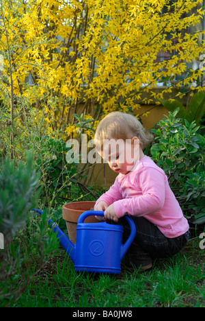 16 month old baby girl playing in the garden Stock Photo