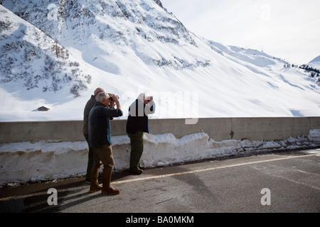 Elderly village inhabitants with binoculars in Hinterrhein, Switzerland Stock Photo