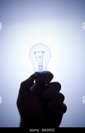 Hand holding a lightbulb Stock Photo