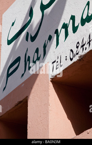 The hand painted sign of a chemist pharmacie in both arabic and french languages just off the place Jemaa El Fna Stock Photo