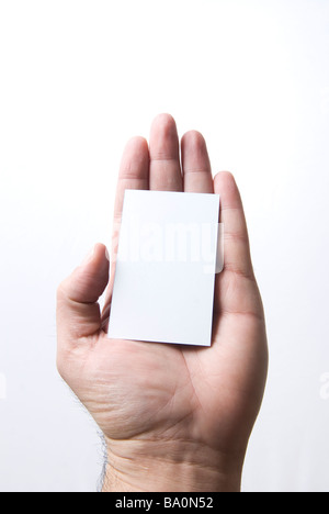 Hand holding a white card sign against a white background Stock Photo