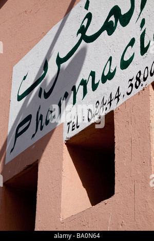 The hand painted sign of a chemist pharmacie in both arabic and french languages just off the place Jemaa El Fna Stock Photo