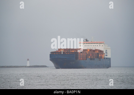 The ACL container ship Atlantic Conveyor passes the lighthouse on McNab's Island in Halifax Harbour, Nova Scotia. Stock Photo