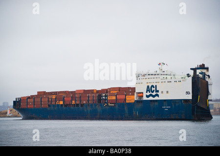 The ACL container ship Atlantic Conveyor passes the lighthouse on George's Island in Halifax Harbour, Nova Scotia. Stock Photo