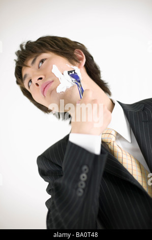 Young businessman shaving Stock Photo