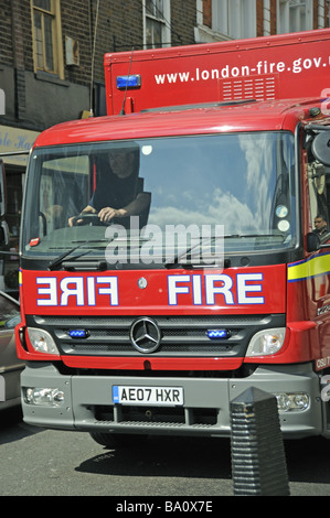 Fire engine with blue lights flashing on emergency call London England UK Stock Photo