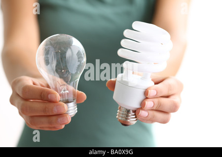 Hands holding traditional and energy efficient light bulbs Stock Photo