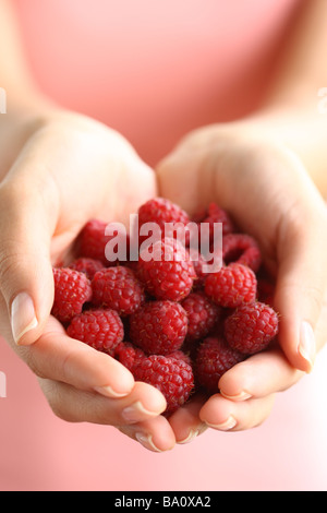 Hands holding red raspberries Stock Photo