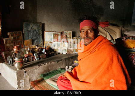 Hindu Indian Yogi Inside His Cave Sitting Down On The Floor Next To Images Of Hinduism Religion Gods Mc Leod Ganj India Stock Photo