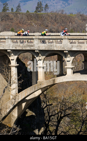 Bike racers crossing the Rowena bridge in Portland, Oregon Stock Photo