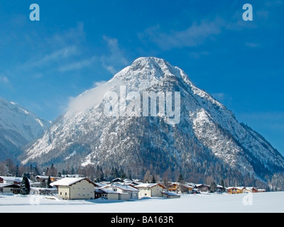 Pretty village at the footage of Tirol mountains  in blue ski winter day Stock Photo