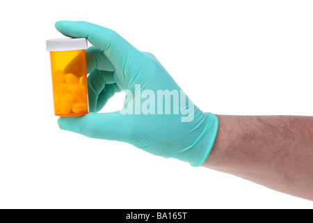 Hand holding pill bottle cutout on white background Stock Photo