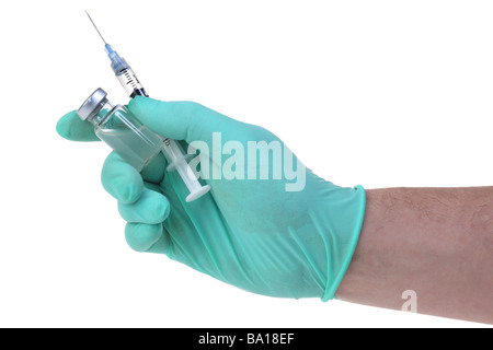 Hand holding syringe and medicine cutout on white background Stock Photo