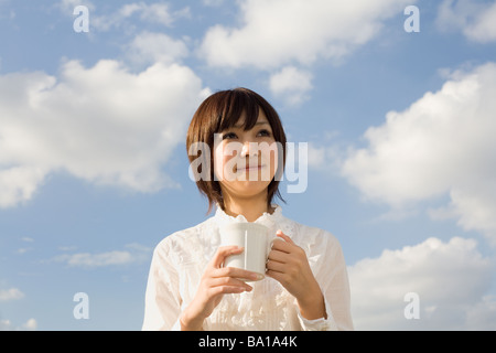 Young woman holding cup Stock Photo