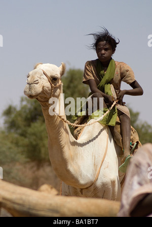 Bedouin children gather at a well in the Sudanese desert as generations have done before them Stock Photo