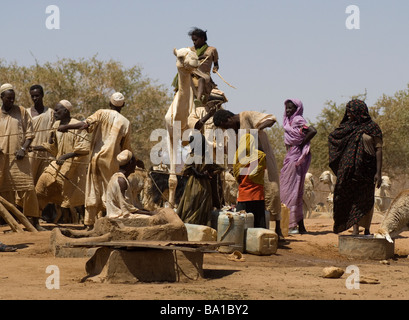 Bedouin children gather at a well in the Sudanese desert as generations have done before them Stock Photo