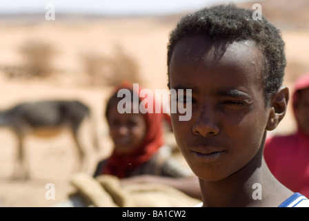 Bedouin children gather at a well in the Sudanese desert as generations have done before them Stock Photo