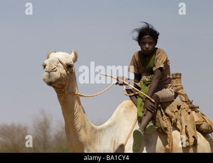 Bedouin children gather at a well in the Sudanese desert as generations have done before them Stock Photo