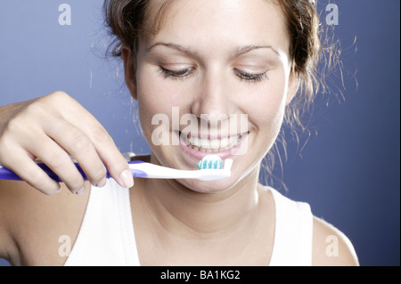 Young woman brushing her teeth portrait Stock Photo